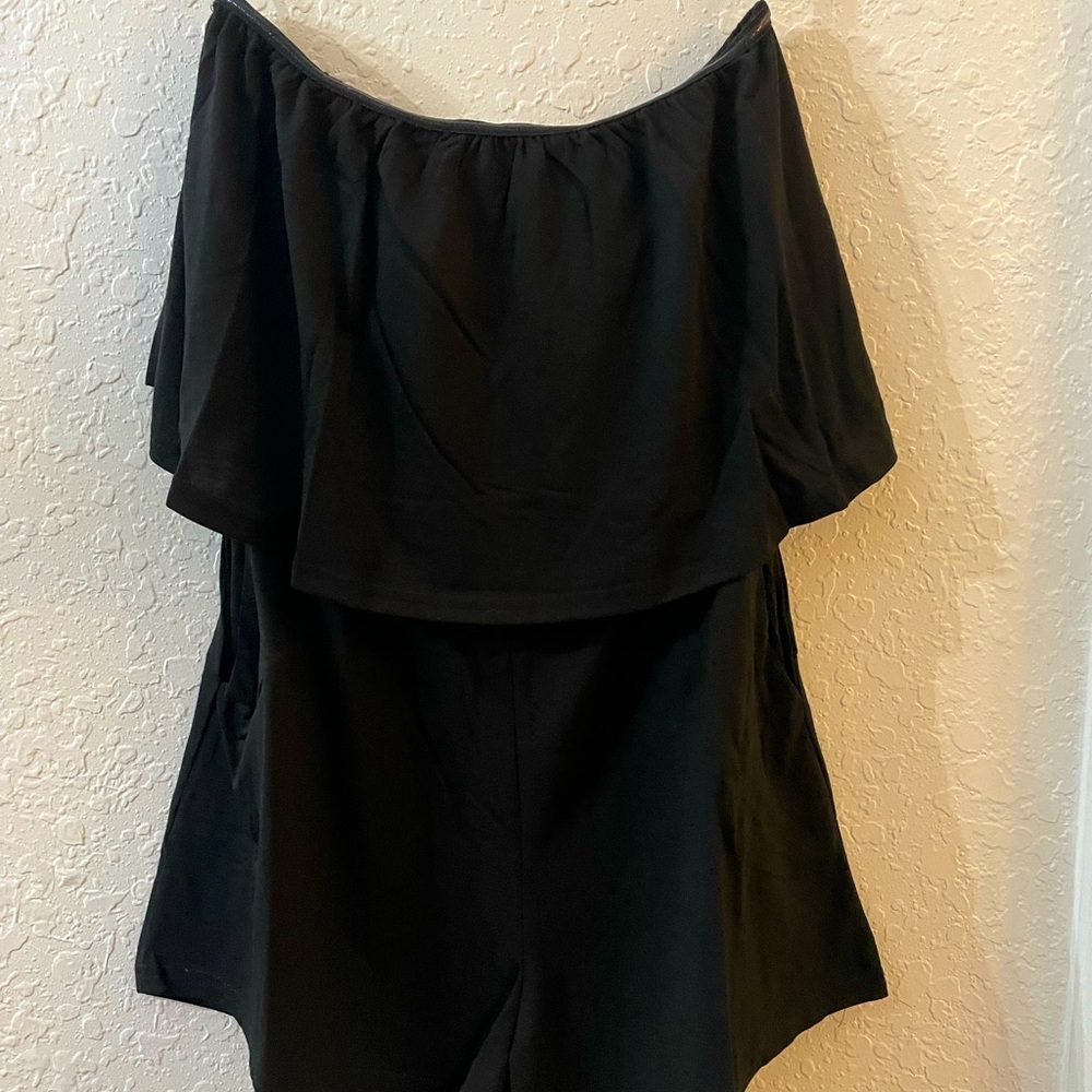 Black strapless romper with pockets.